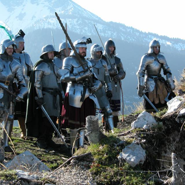 Group of knights in full armor in snowy mountain setting